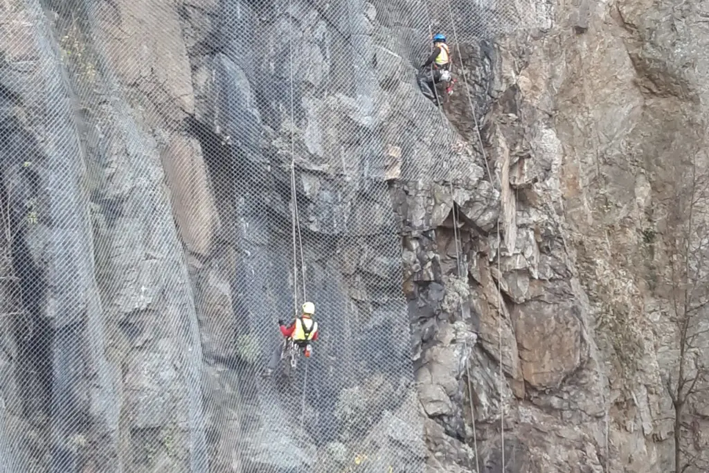 Industrial climber during rope-assisted assembly work
